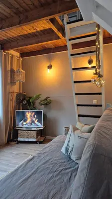a bedroom with a bed and a tv in a room at cottage near the beach in the center.**** in Noordwijk aan Zee