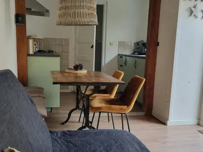 a dining room table and chairs in a kitchen at cottage near the beach in the center.**** in Noordwijk aan Zee