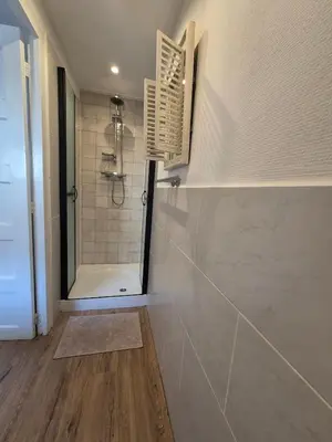 a bathroom with a shower with a toilet and a mirror at cottage near the beach in the center.**** in Noordwijk aan Zee