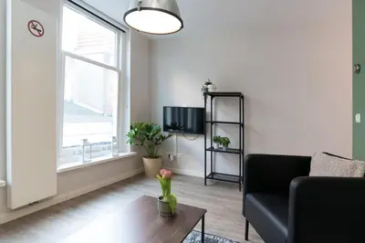 a living room with a couch and a table at Alkmaar City Apartments in Alkmaar