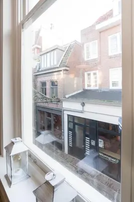 a window with a view of a building at Alkmaar City Apartments in Alkmaar