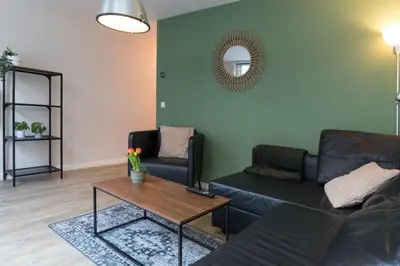 a living room with a couch and a table at Alkmaar City Apartments in Alkmaar