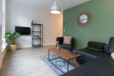 a living room with a couch and a table at Alkmaar City Apartments in Alkmaar