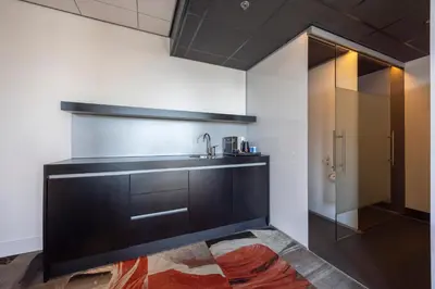 a kitchen with a sink and a mirror at Fletcher Wellness-Hotel Leiden in Leiden