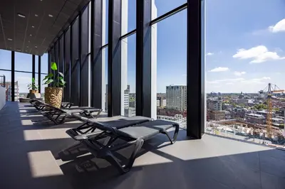a row of chairs in a building with windows at Fletcher Wellness-Hotel Leiden in Leiden