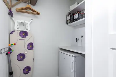 a kitchen with a refrigerator with purple flowers on it at Kustlijn vakantiewoning in Egmond aan den Hoef
