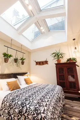 a bedroom with a bed with plants on the wall at Hotel Dwars in Amsterdam