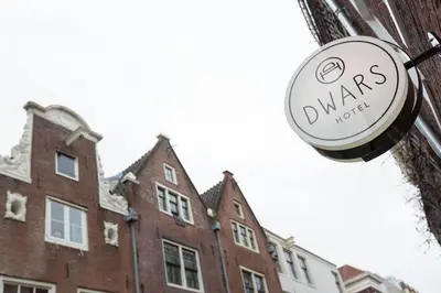 a sign on the side of a building at Hotel Dwars in Amsterdam