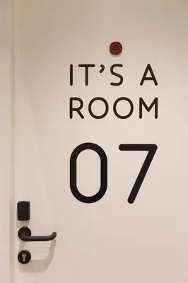 a door with a sign that says its a room at Hotel Dwars in Amsterdam