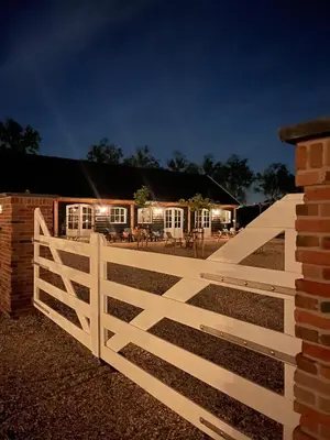 a white fence in front of a house at Noxem b&b in Boesingheliede
