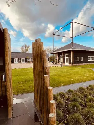 a wooden fence in front of a building at Noxem b&b in Boesingheliede