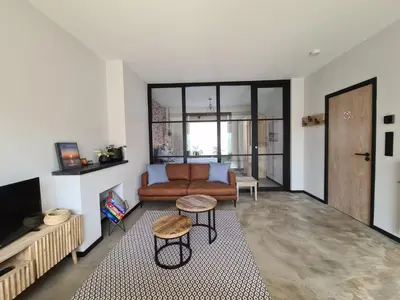 a living room with a couch and a table at De Boulevard 2 in Zandvoort