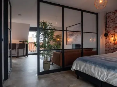 a bedroom with a large glass wall at De Boulevard 2 in Zandvoort