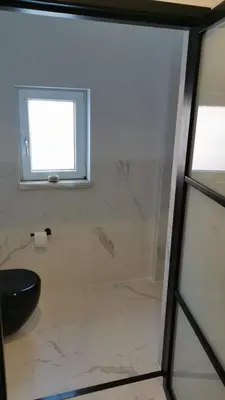 a bathroom with a toilet and a window at De Boulevard 2 in Zandvoort