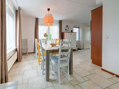 a kitchen and dining room with a table and chairs at Holiday Home in Zeewolde near Forest in Zeewolde