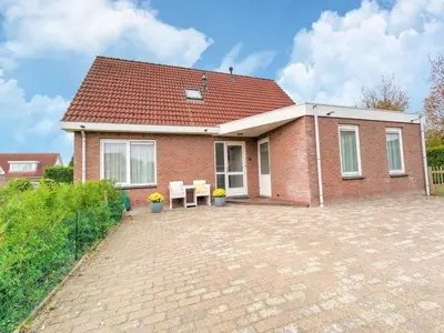 a red brick house with a table in front of it at Holiday Home in Zeewolde near Forest in Zeewolde