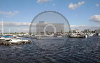 a group of boats docked at a dock in the water at Aqualiving Kempers in Aalsmeer