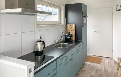 a kitchen with a sink and a counter top at Aqualiving Kempers in Aalsmeer