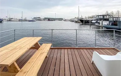 a wooden deck with a bench on a boat at Aqualiving Kempers in Aalsmeer