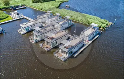 an aerial view of a house in the water at Aqualiving Kempers in Aalsmeer