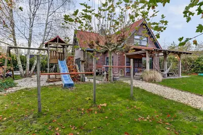 a playground in front of a house at Villa Leeuwerik (4-12 p.) in Zeewolde