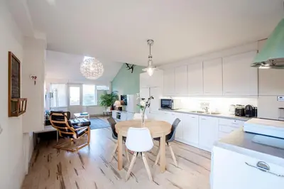 a kitchen and dining room with a table and chairs at De Lijsterhof in Zandvoort