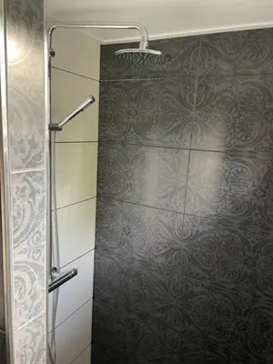 a shower with a glass door in a bathroom at Aangenaam op de Rijn, woonboot, inclusief privé sauna in Alphen aan den Rijn
