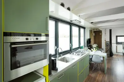 a kitchen with a sink and a stove at Aangenaam op de Rijn, woonboot, inclusief privé sauna in Alphen aan den Rijn