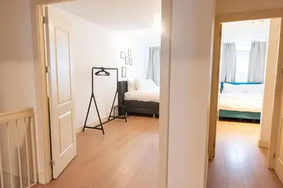 a hallway with a room with two beds and a mirror at Canal View Apartment in Amsterdam