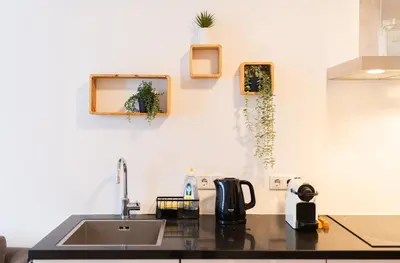 a kitchen with a sink and a counter top at Canal View Apartment in Amsterdam