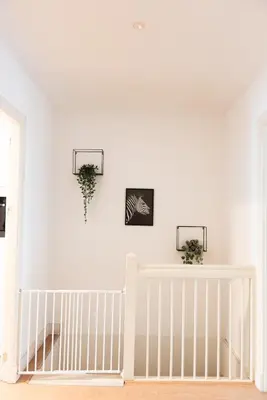 a white crib in a room with white walls at Canal View Apartment in Amsterdam