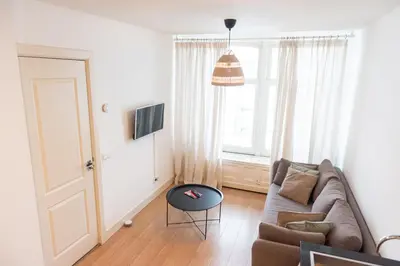 a living room with a couch and a table at Canal View Apartment in Amsterdam