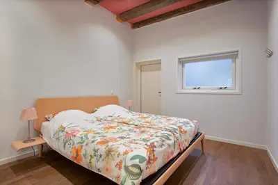 a bedroom with a bed and a window at Five Churches View apartments in Haarlem