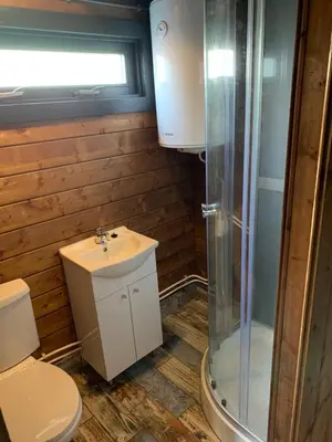 a bathroom with a toilet and a sink and a shower at Chalet - B&B de Koog in Uitgeest
