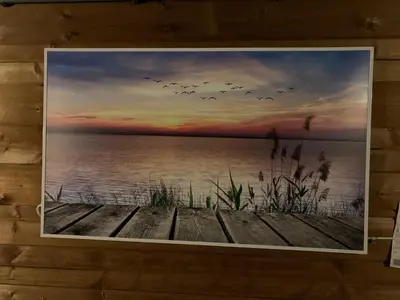 a painting of a lake with birds flying over it at Chalet - B&B de Koog in Uitgeest