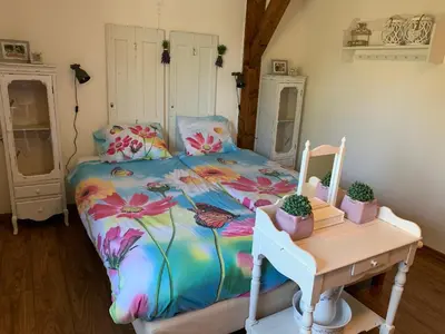 a bedroom with a bed with a dresser and a desk at Christinahoeve Logies Oude Deel in Boskoop
