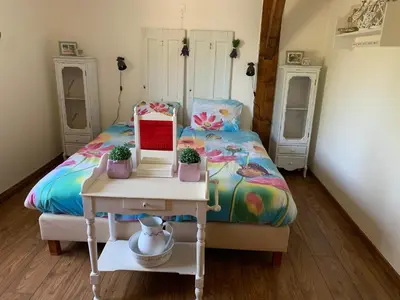 a small bedroom with a bed and a table with a table at Christinahoeve Logies Oude Deel in Boskoop