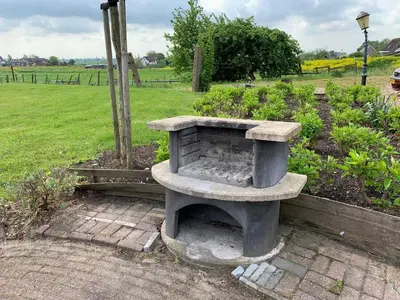 a stone bench sitting in the middle of a garden at Christinahoeve Oude Deel #4 in Boskoop