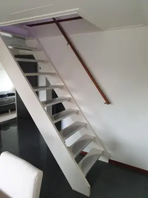 a white staircase in a room with a white chair at Lovely Bungalow 8p close to beach and Amsterdam in Opmeer
