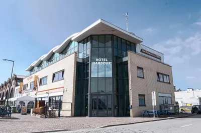 a building with a sign on the front of it at Harbour Hotel IJmuiden in IJmuiden
