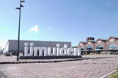 a building with a sign that reads jinn bitten at Harbour Hotel IJmuiden in IJmuiden