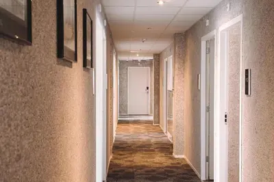 a hallway of an office building with a long corridor at Harbour Hotel IJmuiden in IJmuiden
