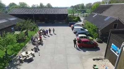 an overhead view of a parking lot with a group of people at Mariahoeve-Logies #'t Hooihuis in Woubrugge
