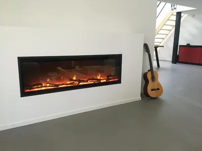 a fireplace in a living room with a guitar at Luxe vakantiehuis met sauna De Barn Bergen in Bergen