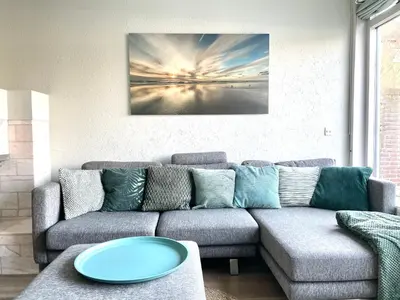 a living room with a couch and a table at Alibi aan Zee in Wijk aan Zee