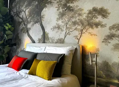 a bedroom with a bed with colorful pillows on it at Daen’s Greenhouse in Utrecht