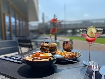 a table with a bowl of food and a drink at Holiday Inn Express - Almere by IHG in Almere
