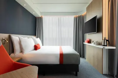 a hotel room with a bed and a television at Holiday Inn Express - Almere by IHG in Almere