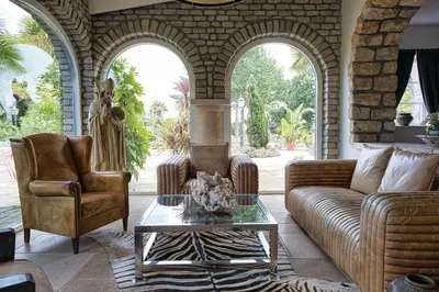 a living room with two chairs and a couch and a table at Boutique Villa De Zuilen in Hillegom