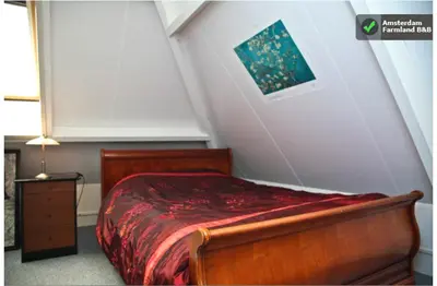 a bedroom with a bed and a painting on the wall at Amsterdam Farmland in Amsterdam